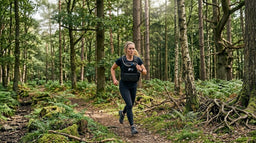 Woman rucking outdoors wearing a Force Fitness weighted vest on a countryside trail